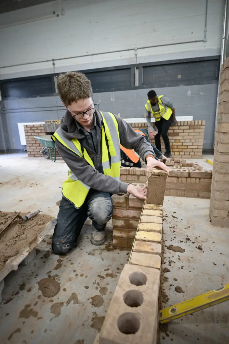 Students working on brick walls